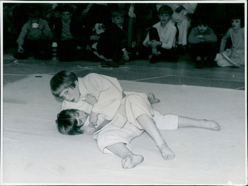 Susan Selling holds down Mandy Bell to win the girls under-10 judo final. - Vintage Photograph