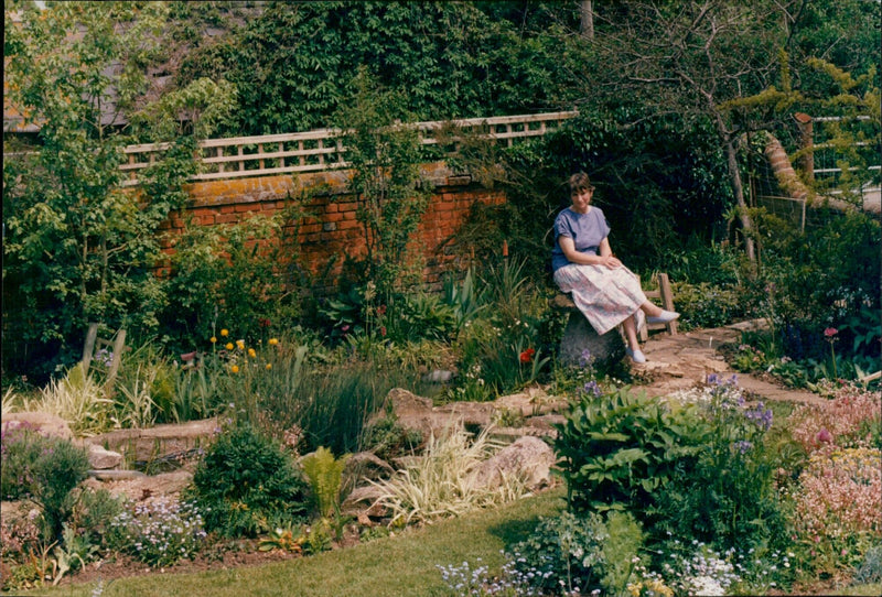 Mrs. Rogers stands in a field of Model Farm