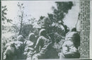 U.S. soldiers crouch behind as they battle against their enemy in Ryuku Island. - Vintage Photograph