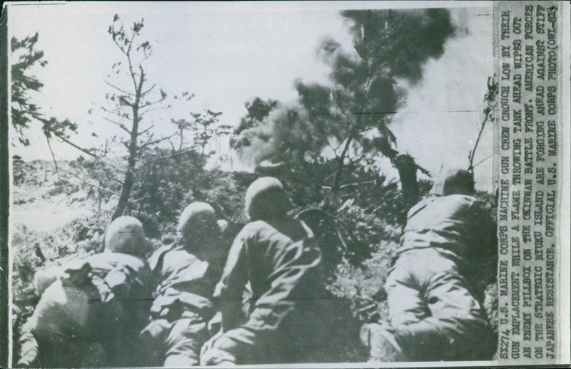 U.S. soldiers crouch behind as they battle against their enemy in Ryuku Island. - Vintage Photograph