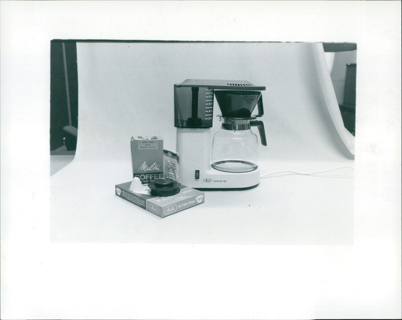 The Melitta Coffee Maker, released in 1930, is seen here with its lid, water tank, and hotplate. - Vintage Photograph