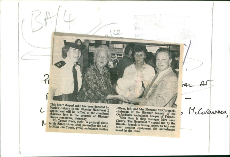Mr Trevor Nash presents a heart-shaped cake to Miss Jan Couch and Mrs Florence McCormack for the Bicester Heartbeat 2 appeal. - Vintage Photograph