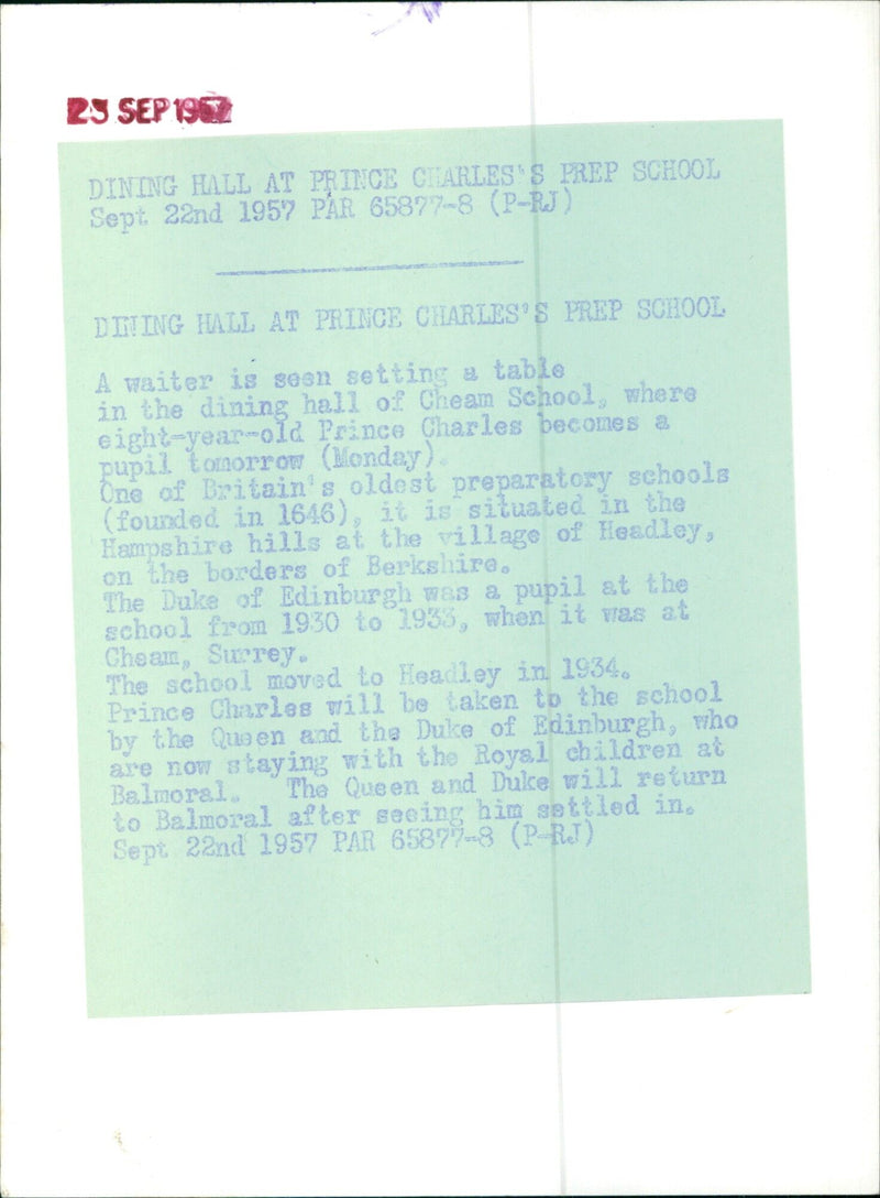 On September 23rd 1957, a waiter sets a table in the dining hall of Cheam School, where Prince Charles will become a pupil the following day. - Vintage Photograph