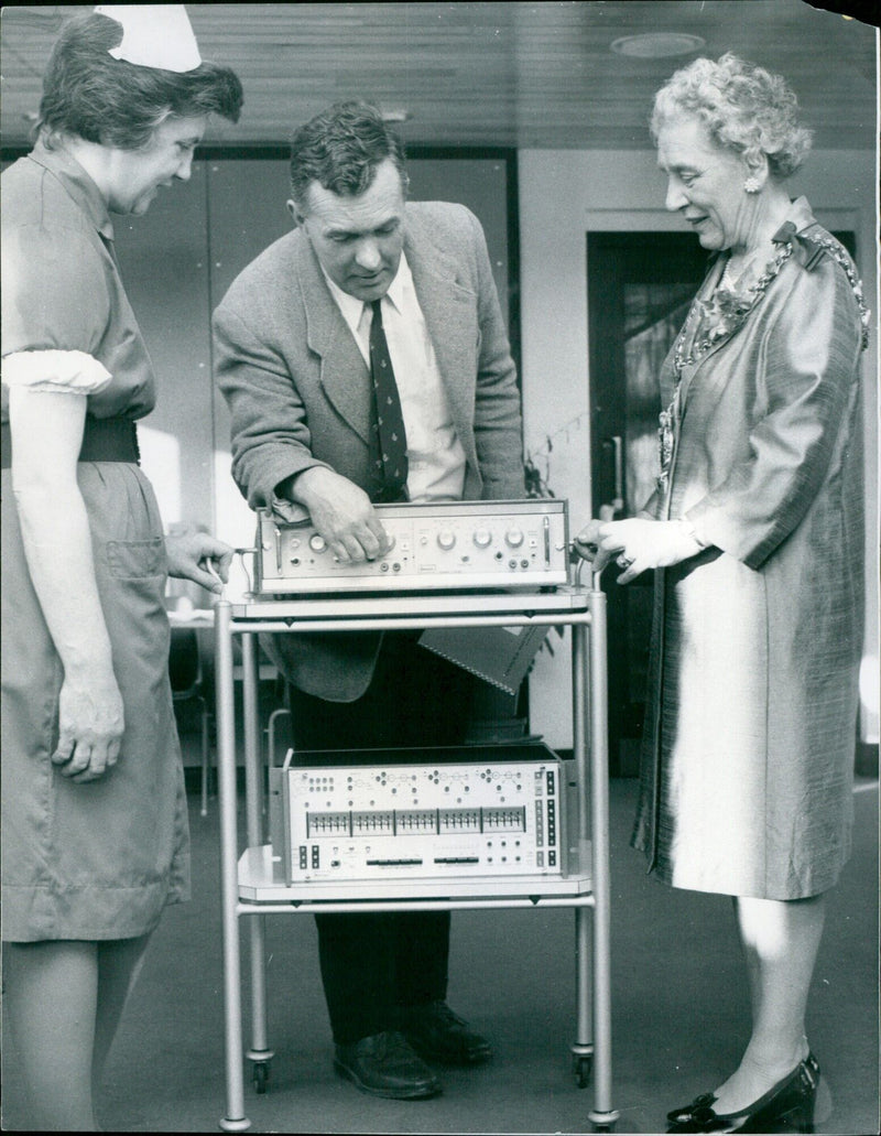 Councillor Dr Joan Norris, Mayor of Abingdon, listens to Dr Lloyd explain the workings of a machine. - Vintage Photograph
