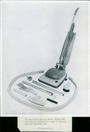 The Hoover De-Luxe cleaner (Model 652) is seen here with its range of cleaning tools and Hooverflex hose. - Vintage Photograph