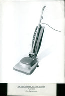 A woman demonstrating the new Hoover De Luxe Cleaner Model 652A. - Vintage Photograph