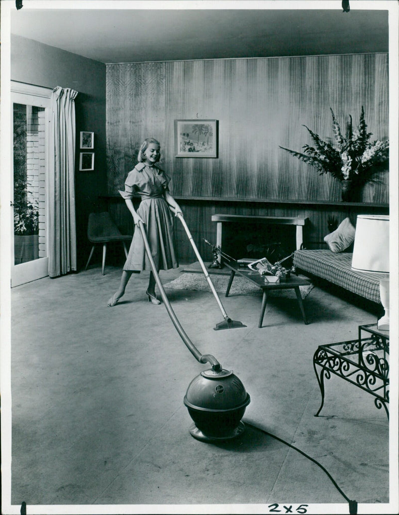 A Hoover Constellation cleaner with double-stretch plastic hose. - Vintage Photograph