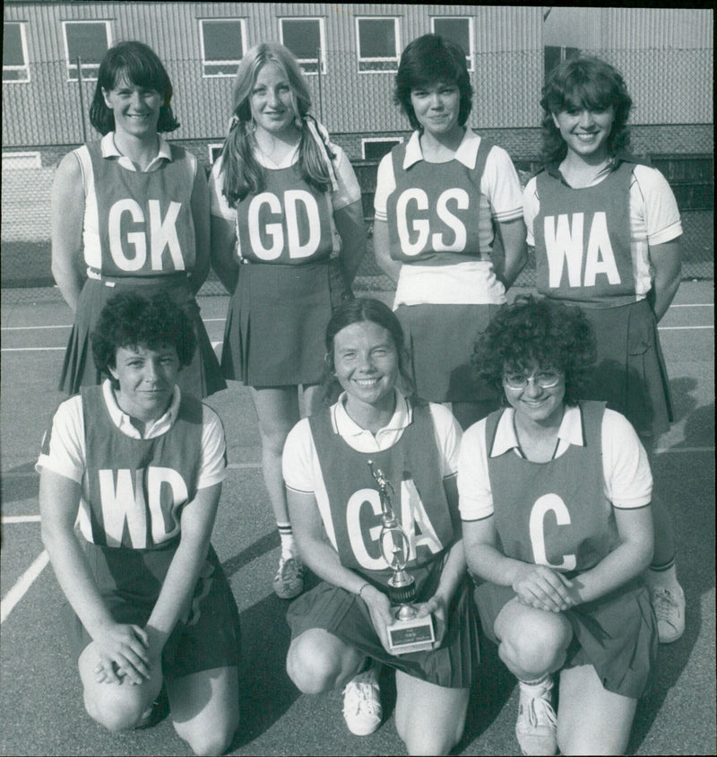 Netball players pose with trophies after a challenge match. - Vintage Photograph