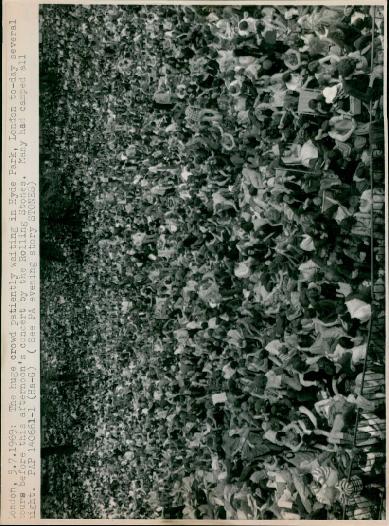 A large crowd of fans waits in Hyde Park ahead of a Rolling Stones concert. - Vintage Photograph