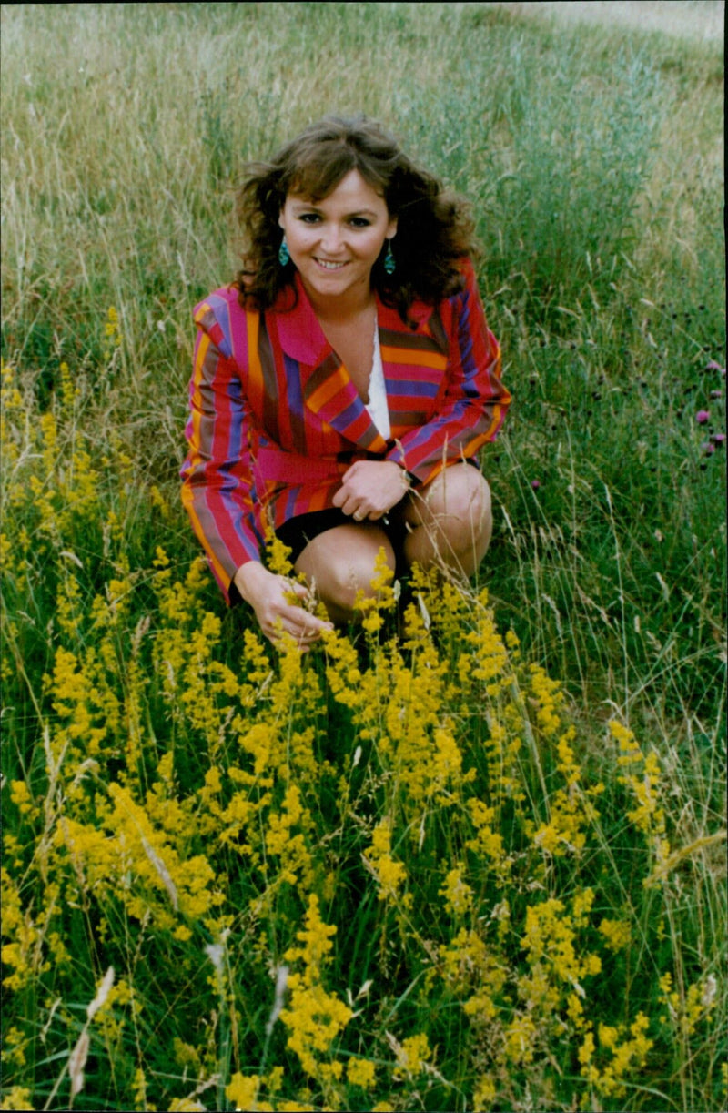 Conservationist Jessica Rea inspects Ladies Bedstraw at Wigwell's Wildlife Nature Reserve in Charlbury. - Vintage Photograph
