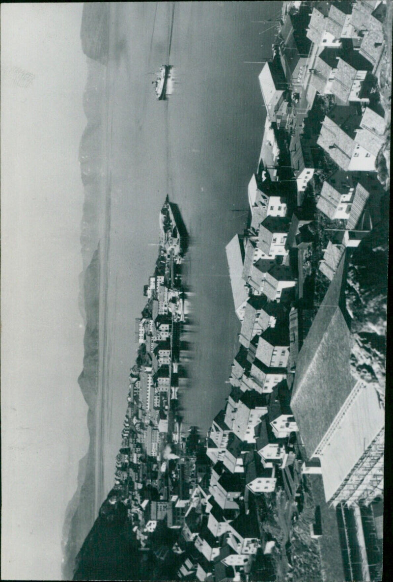 A town perched on the top of a mountainous landscape in Europe. - Vintage Photograph