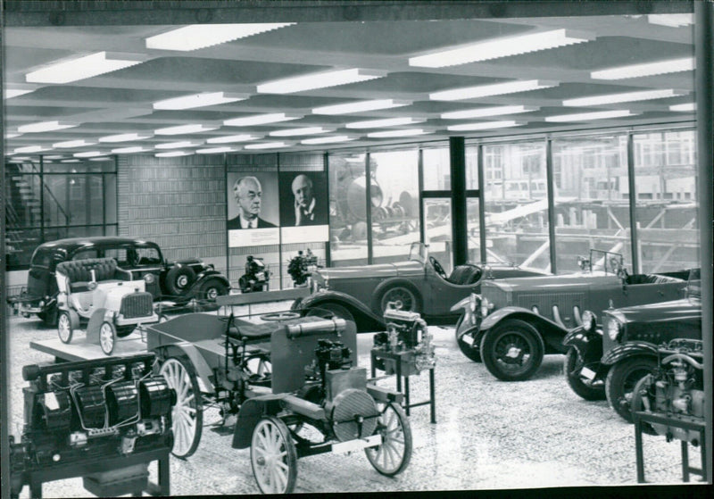 The Daimler-Benz Museum in Stuttgart holds a variety of vehicles from the past, including a 1898 Daimler lorry and a people's car of 1904 with a 1.4 litre 4 bhp engine capable of reaching 18.6 mph. - Vintage Photograph