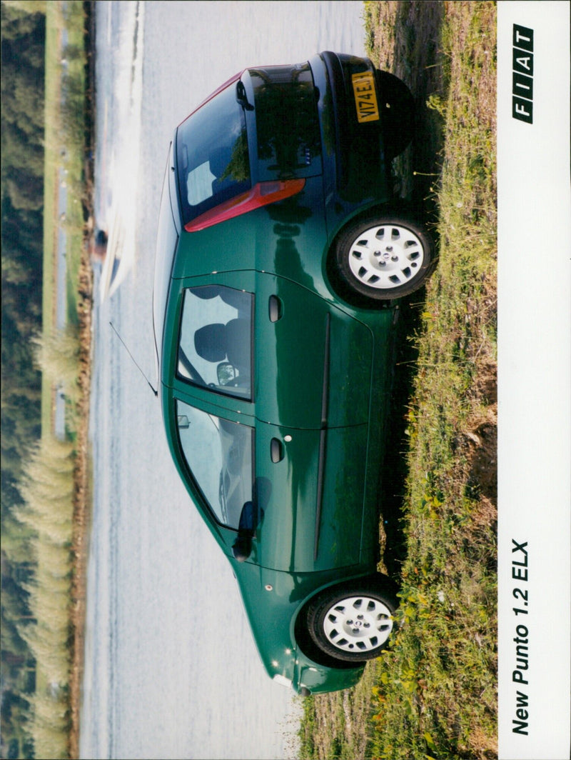 The New Punto 1.2 ELX T VI74 E FIAT on display at an auto show in Milan. - Vintage Photograph