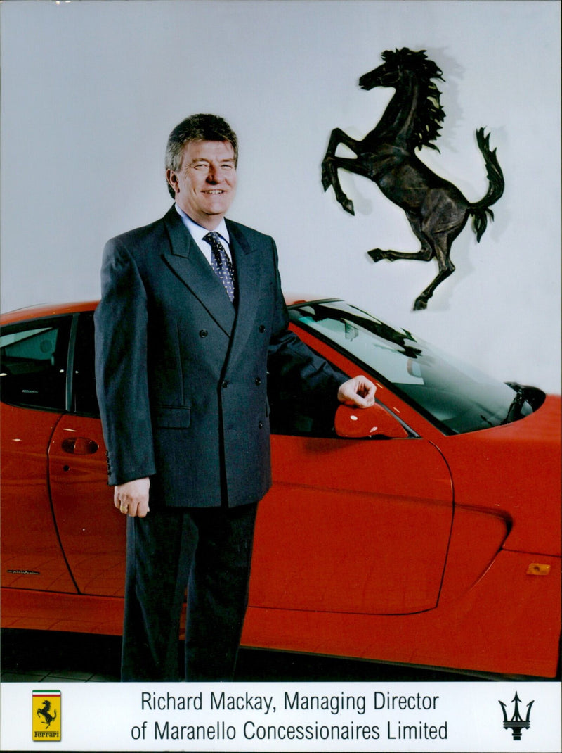 Richard Mackay, Managing Director of Maranello Concessionaires Limited, inspects a new Ferrari 822. - Vintage Photograph