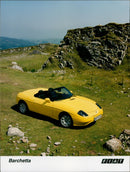 A Fiat Barchetta N974 car on display in a car showroom. - Vintage Photograph