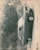 A Hillman Avenger Super 00 car is presented at the CHRYSLER United Kingdom Ltd. showroom. - Vintage Photograph