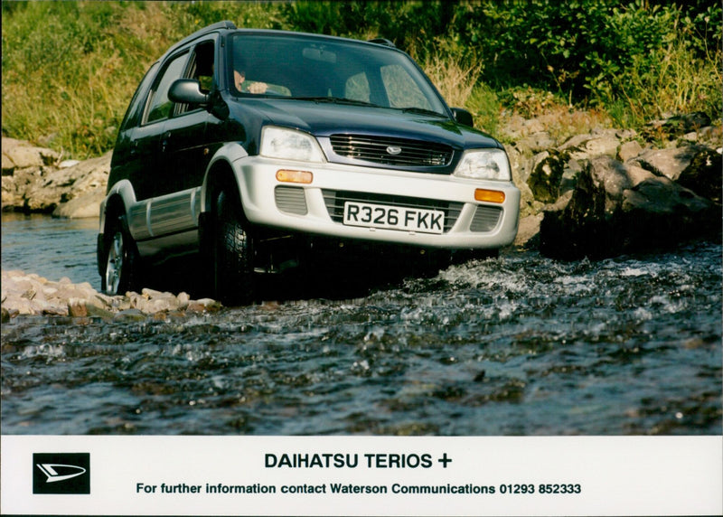 A Daihatsu Terios car driving through a rural landscape. - Vintage Photograph