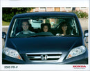 A man admires a 2005 Honda FR-V H, one of the first models released under the company's "The Power of Dreams" slogan. - Vintage Photograph