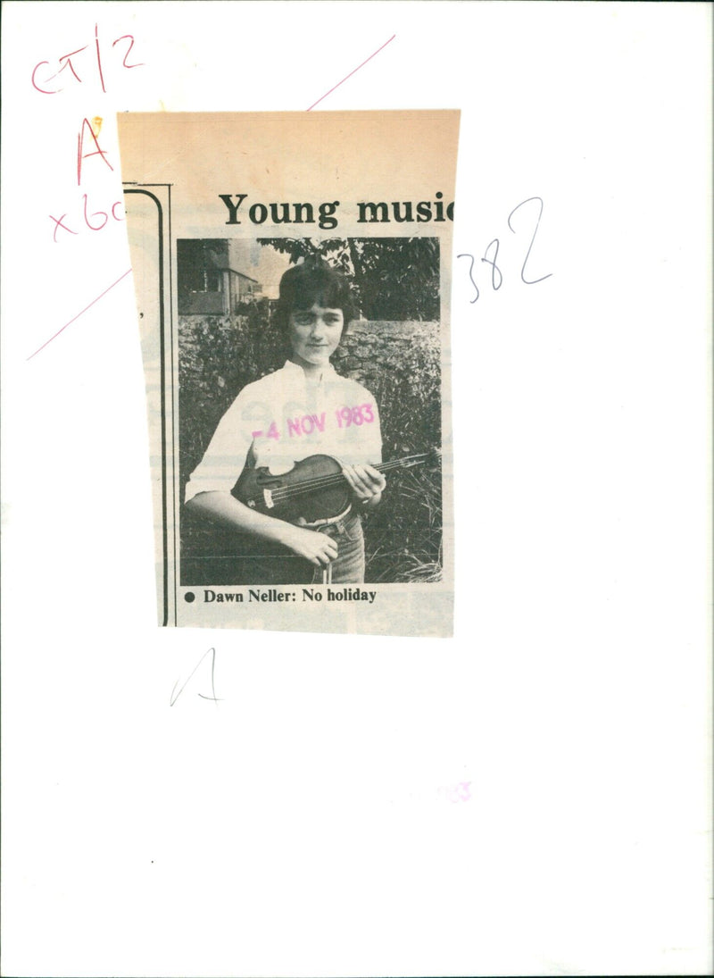 A young musician plays guitar in a city park, despite the cold weather. - Vintage Photograph