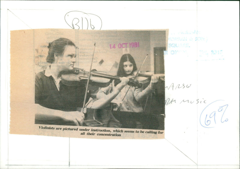 Two violinists concentrate on their music lesson. - Vintage Photograph
