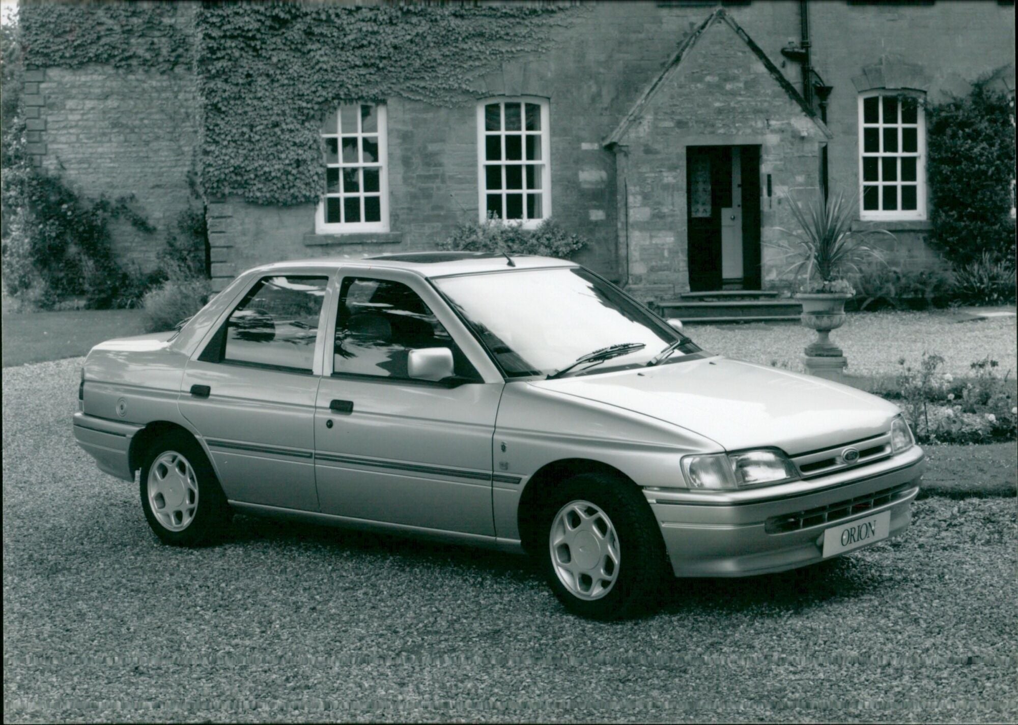 The Ford Orion Ghia Injection 23 AMG is seen in a car dealership. - Vi