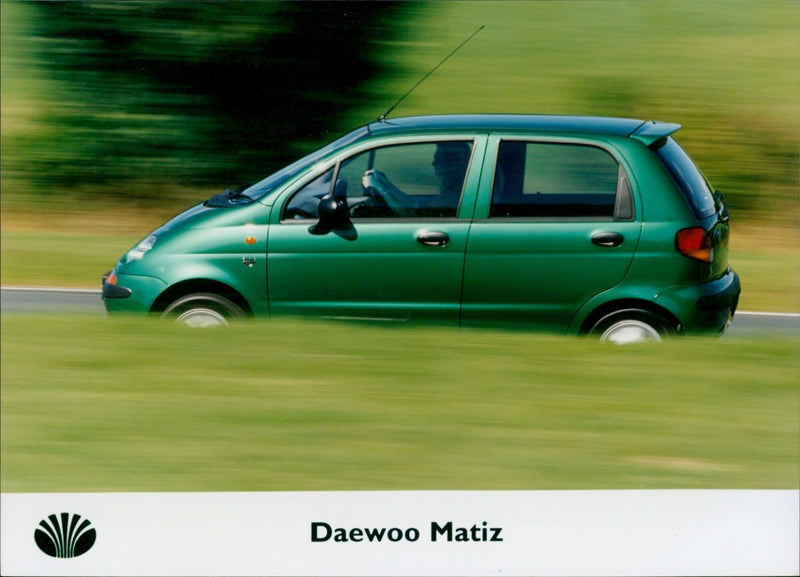 A Daewoo Matiz taxi passes a busy street in Seoul, South Korea. - Vintage Photograph