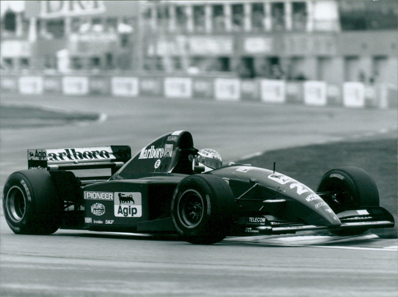 Jean Alesi celebrates after winning the 1995 Canadian Grand Prix driving a Ferrari. - Vintage Photograph