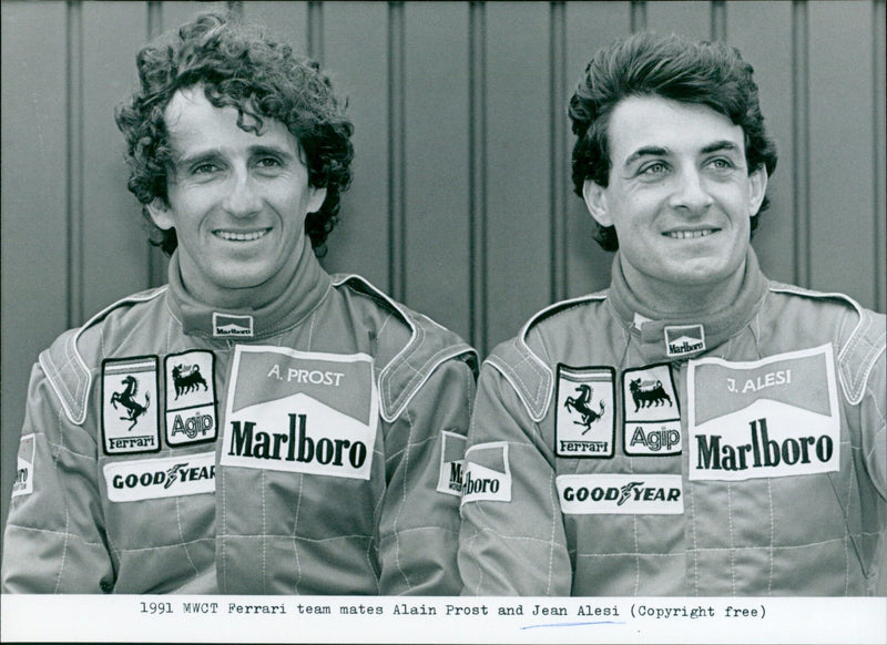 Two Formula One drivers, Alain Prost and Jean Alesi, pose with their Ferrari team car. - Vintage Photograph