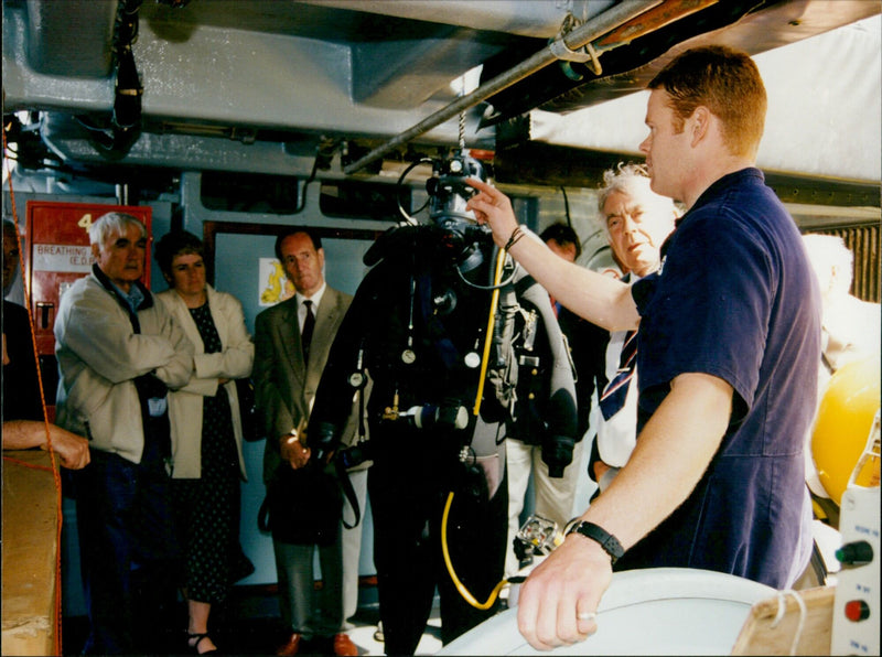 Royal Navy personnel aboard HMS Queen Elizabeth prepare to launch a Phantom fighter jet. - Vintage Photograph