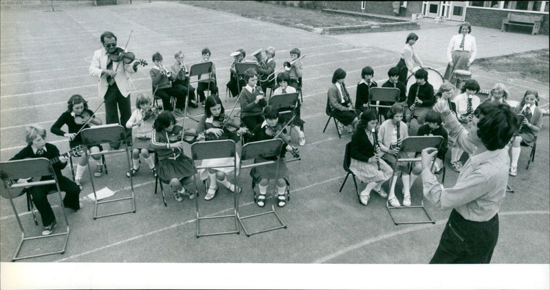 Students of Stephen Freeman Primary School in Didcot, England, rehearse with their music teacher and headmaster. - Vintage Photograph