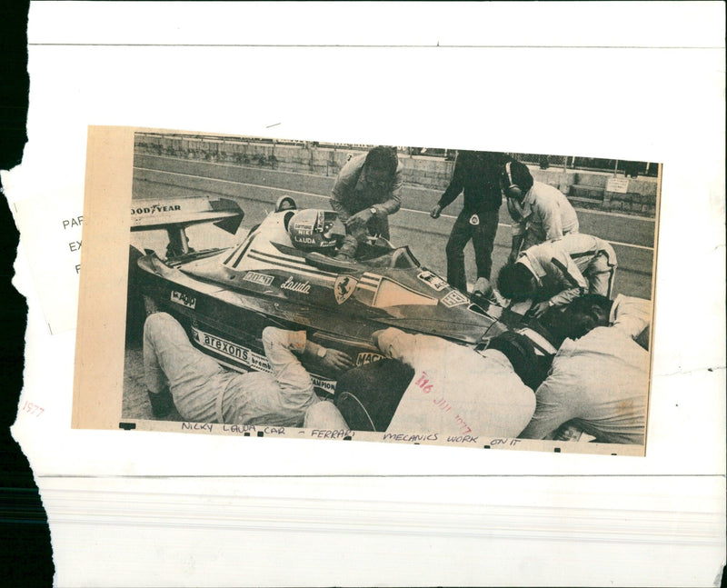 Mechanics work on a Ferrari in preparation for a race. - Vintage Photograph