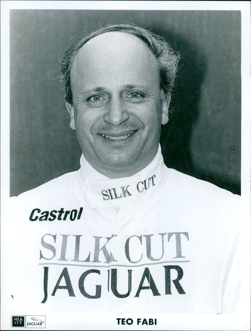 Race car driver Teo Fabi poses with a Silk Cut Jaguar at the Oxford Mail in England. - Vintage Photograph