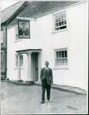Mr. Norman Lieberman stands outside the newly renovated Kings Arms Inn. - Vintage Photograph
