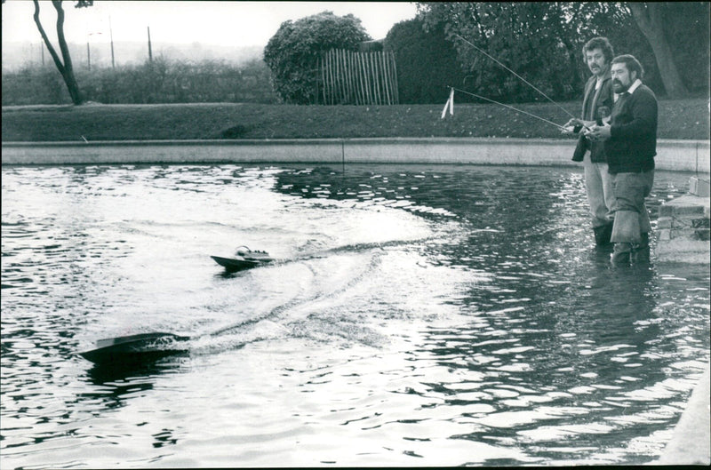 Willis and Len Thomas test their radio-controlled model boats at Inksey Lake. - Vintage Photograph