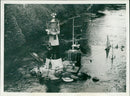 A model lighthouse stands outside a cottage in Lambourn, England. - Vintage Photograph