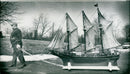 John Montesi of New London, Conn., parades one of his 19 authentic scale models of Italian 19th century fishing and sailing vessels. - Vintage Photograph
