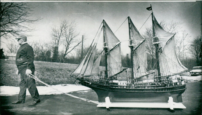John Montesi of New London, Conn., parades one of his 19 authentic scale models of Italian 19th century fishing and sailing vessels. - Vintage Photograph
