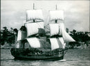 Mr. B. Sewell sails his 22-foot model of the Endeavour in the Rangitoto Channel, New Zealand. - Vintage Photograph