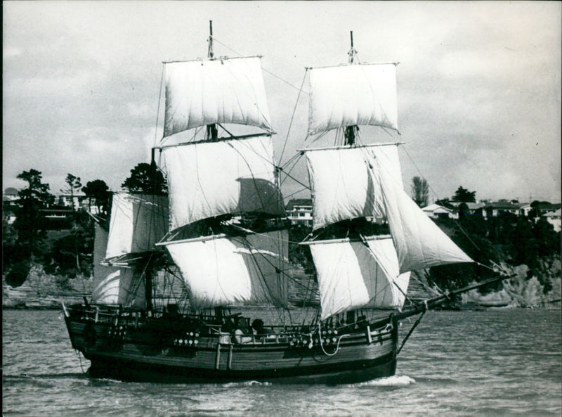 Mr. B. Sewell sails his 22-foot model of the Endeavour in the Rangitoto Channel, New Zealand. - Vintage Photograph