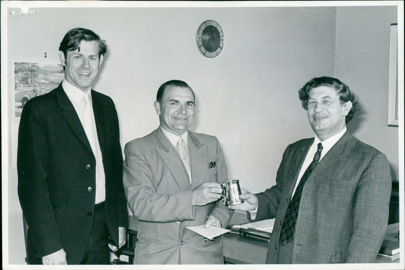 Mr. G. J. Rowland receives a pewter tankard with a three-diamond long service star to commemorate his 30 years of service with Esso. - Vintage Photograph