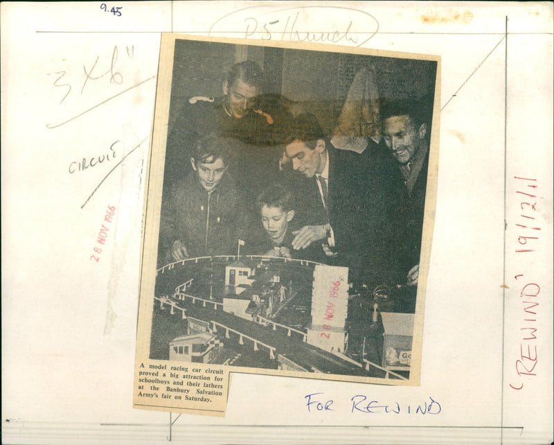 Boys and their fathers enjoy a model racing car circuit at Banbury Salvation Army's fair. - Vintage Photograph