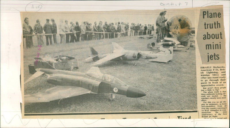 Miniature jets stand ready to go through their paces in front of an appreciative crowd at a model aircraft display in Abingdon, England. - Vintage Photograph