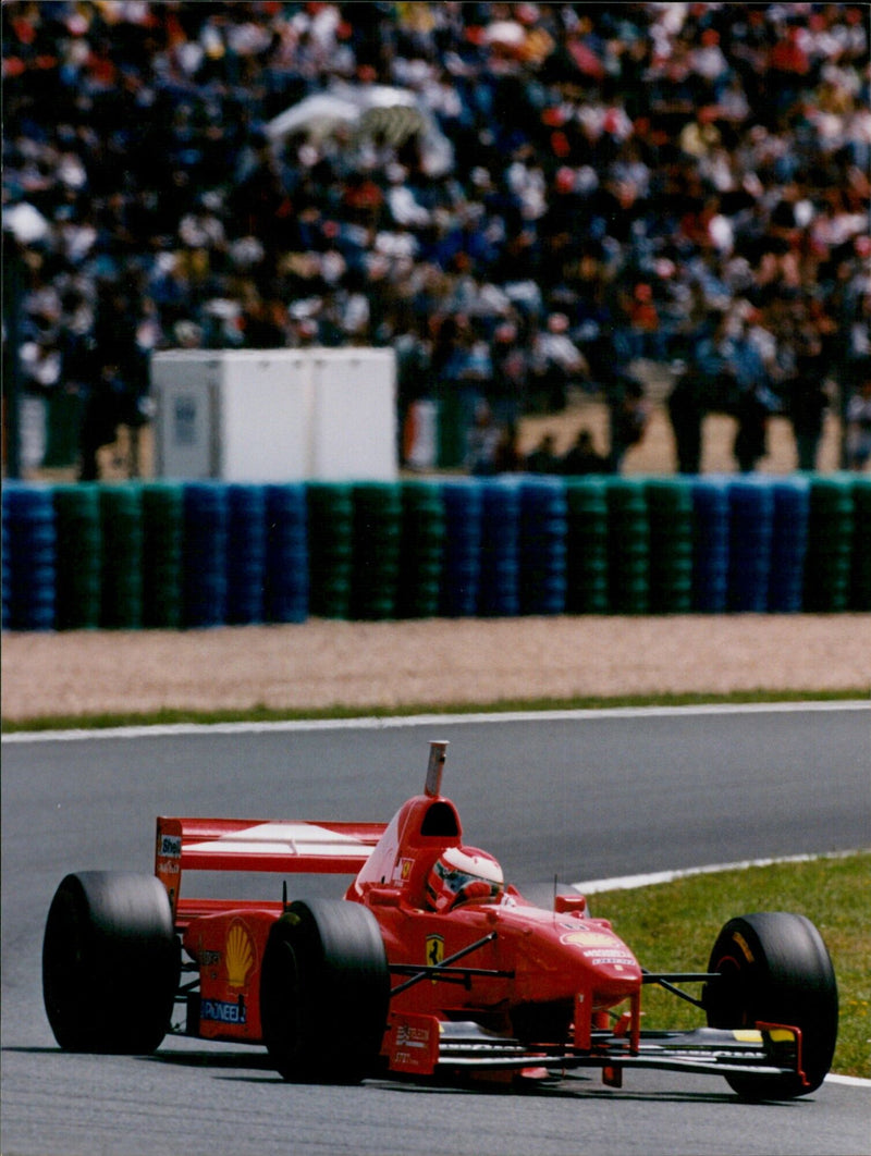 Eddie Irvine of the Ferrari team celebrates a 3rd place finish in the 1997 French Grand Prix. - Vintage Photograph