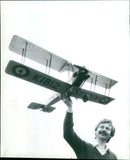 Charles Newman with a model of an Avro biplane. - Vintage Photograph
