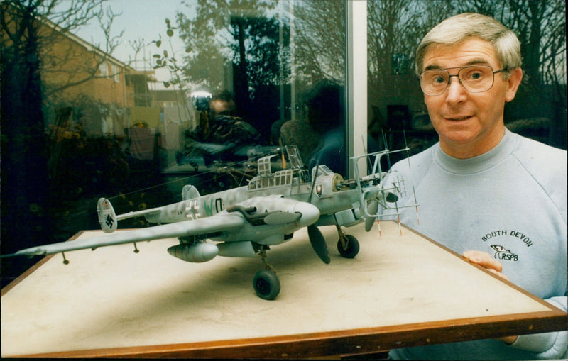 Tony Clements from Abingdon poses with a Messerschmitt plane model. - Vintage Photograph