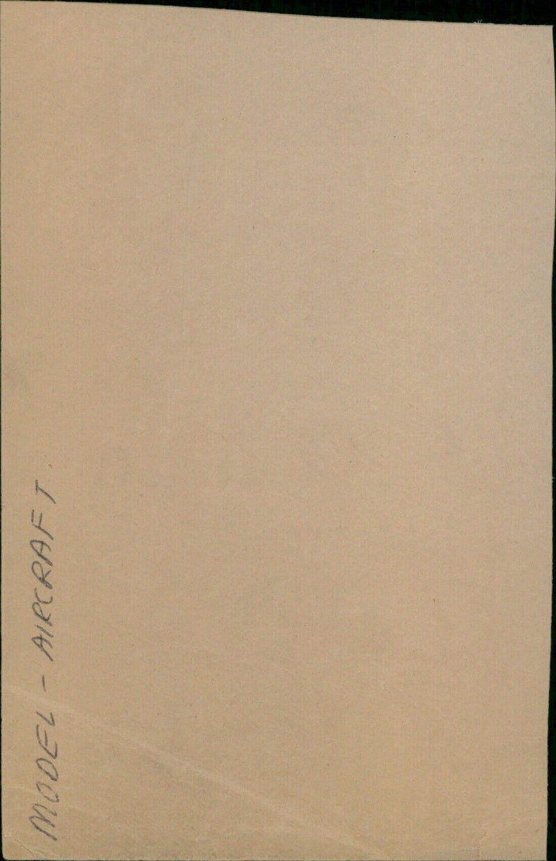 A model aircraft being inspected by a group of people. - Vintage Photograph