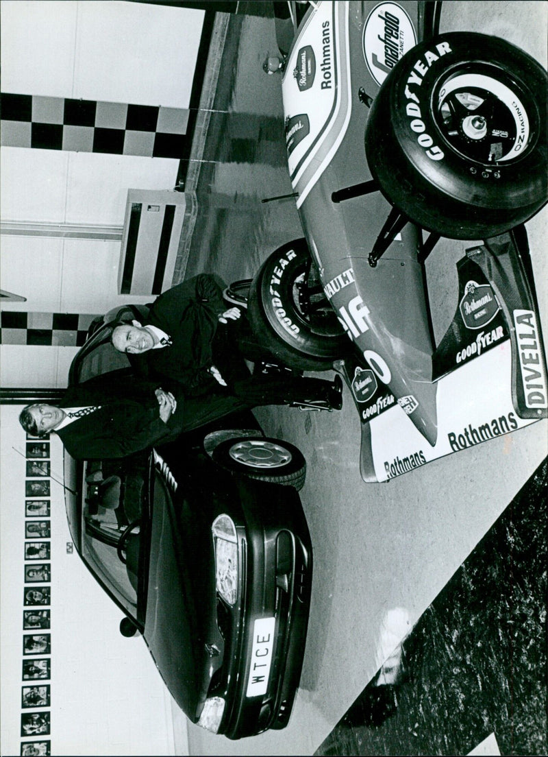 Frank Williams and Michel Gigou of Renault pose with a Laguna and Damon Hill's F1 car at the Williams announcement of their touring car team. - Vintage Photograph