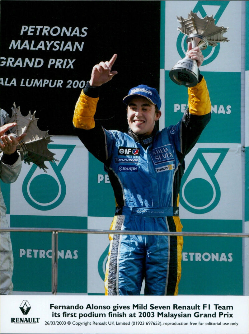 Fernando Alonso of the Mild Seven Renault F1 Team celebrates his first podium finish at the 2003 Malaysian Grand Prix. - Vintage Photograph