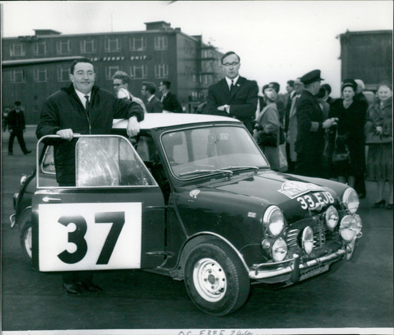 Paddy Hopkirk and Henry Liddon pose together after winning a race. - Vintage Photograph