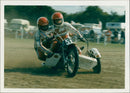 Retiring grasstrack sidecar passenger Dane Harris sits in the sidecar of Roger Measor during a farewell ride. - Vintage Photograph